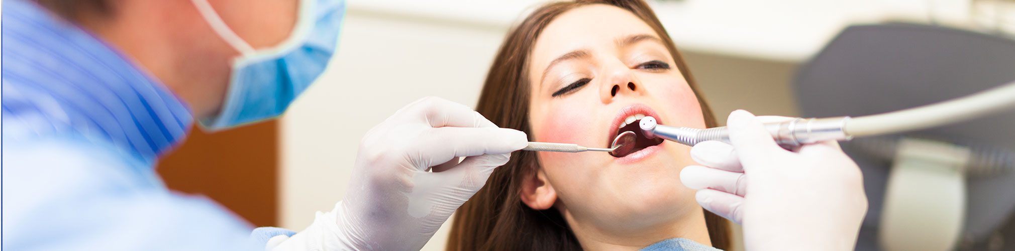 Female getting her teeth polished during a dental exam | Robson Family Dentistry in Bellefontaine, OH