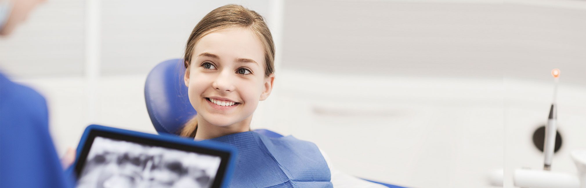 Young girl smiling while talking to a dental professional | Robson Family Dentistry in Bellefontaine, OH
