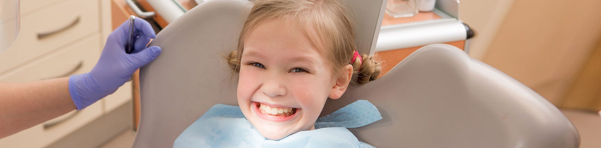 Young girl smiling during a dental exam